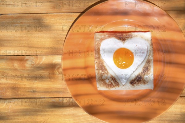 Breakfast of toast and eggs in the shape of heart