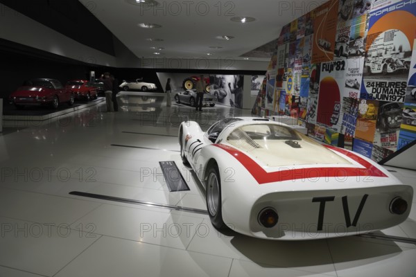Porsche 906 Carerra 6, white racing car with red stripes, embedded in a colourful historical exhibition, New Porsche Museum 2009, Stuttgart, Baden-Württemberg, Germany