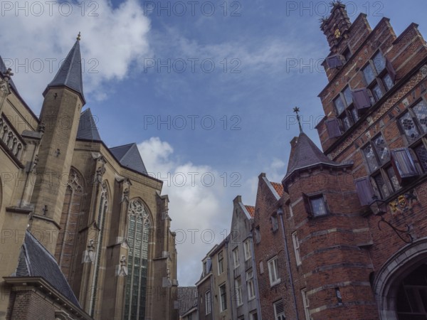 Gothic church and historic buildings under a blue sky, nijmegen, gelderland, the netherlands