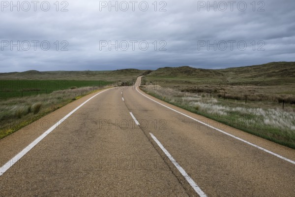 Country road under a cloudy sky in Extremadura, Spain