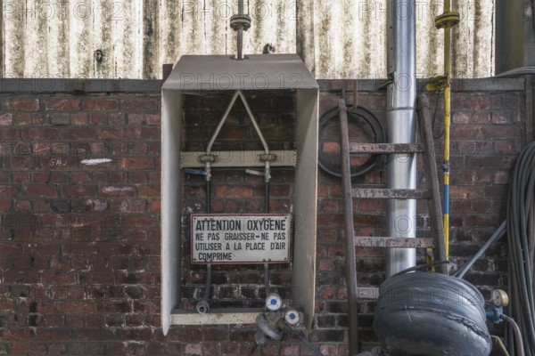 Industrial wall with signs and old metallic structures, clearly visible decay, steelworks HF4, Lost Place, Dampremy, Charleroi, Province of Hainaut, Belgium