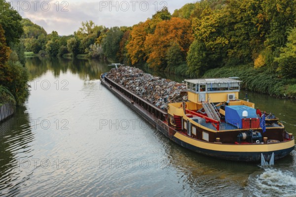 Transportation industry. Ship barge transports scrap metal and sand with gravel. Barge loaded with scrap metal is on the roadstead. Scrap metal transportation by water. Barge laden by metal salvage. Ship with scrap metal. Stuttgart, Ludwigsburg, Marbach am Neckar, Freiberg am Neckar, Germany, Baden Wurttemberg