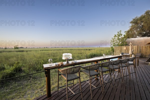 Terrace with bar on the main channel, Okuti Camp, Moremi Game Reserve, Okavango Delta, Maun, Botswana