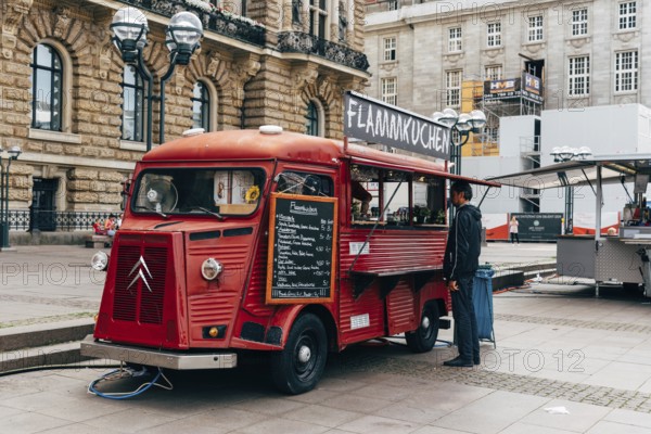Hamburg, Germany, August 4, 2019: Unidentified man is buying flammkuchen or tarte flambee in a food truck