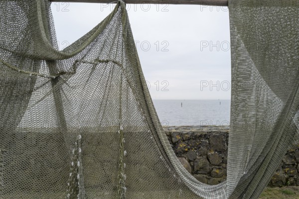 Fishing nets to dry on the road by the sea