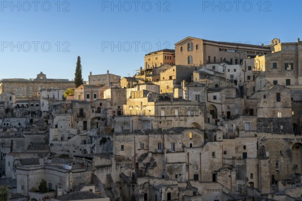 Matera, Italy, 26 November, 2023: view of the old city center of Matera with the stone houses in the last rays of sunlight