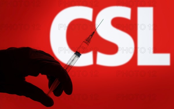A gloved hand holding a syringe in front of the CSL logo. CSL Limited is an Australian biotechnology company.