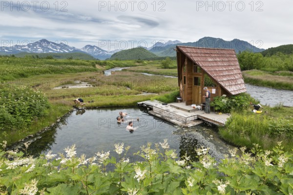 NALYCHEVO, KAMCHATKA PENINSULA, RUSSIA, JULY 11, 2014: Goryacherechensky group hot springs in nature park Nalychevo, people swimming in the natural thermal pools. Kamchatka, Far East, Russia