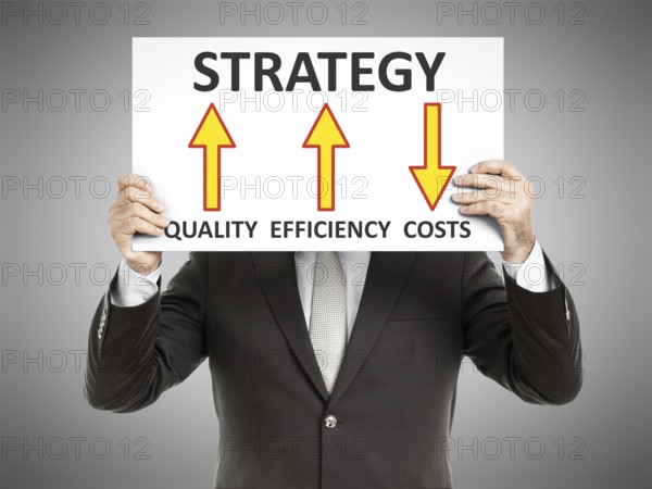 A business man holding a paper in front of his face with a strategy