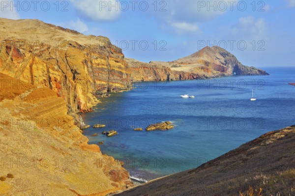 White yachts lit sunset. Quiet ocean cove on the island of Madeira. Calm on the Atlantic Ocean