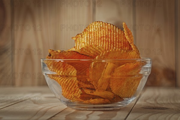 Transparent Glass Bowl Of Potato Chips With Paprika