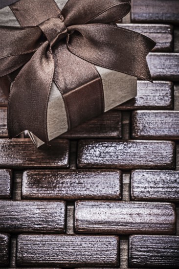Wrapped giftbox on wooden wicker matting holidays concept