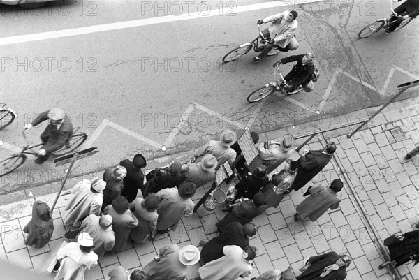 Bus stop in Stockholm in 1953. People are waiting for the bus at the bus stop. Stockholm Sweden 1953, Kristoffersson ref 1-12
