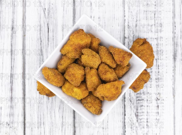 Homemade Chicken Nuggets on vintage background (selective focus, close-up shot)