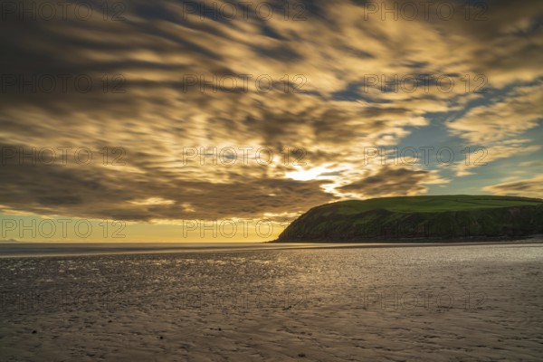 Sunset and dark clouds over the St Bees Heritage Coast near Whitehaven in Cumbria, England, UK