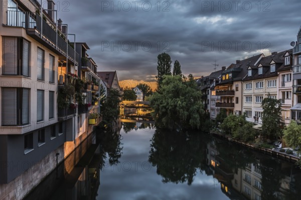 Neurenberg, Bavaria, Germany, 07 26 2018: Historical buildings of old town, reflected in the water of the River Pengnitz