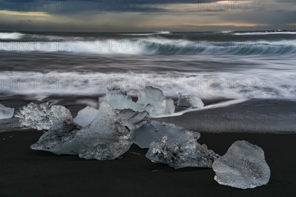 Icebergs from Vatnajokull glacier, drop into Jokulsarlon lake and then to the Ice beach in Iceland. Global warming