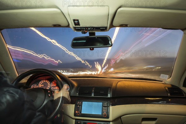 Car interior on driving. Blurred night lights