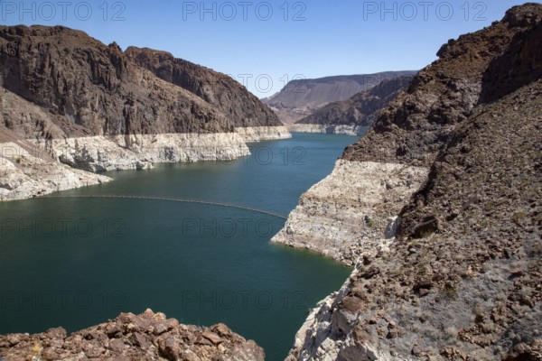 Colorado River reservoir near the dam with coloured rock face