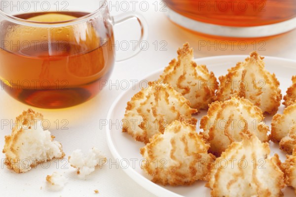 Plate of coconut macaroon cookies and cup of tea