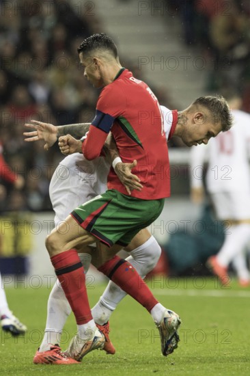 Football match, captain Cristiano RONALDO CR7 Portugal right, looking from the side in a duel with Kamil PIATKOWSKI Poland, holding and pulling each other by the jersey, Cristiano RONALDO Portugal steps with his left foot on the left foot of his opponent, Estadio do Dragao, Porto, Portugal