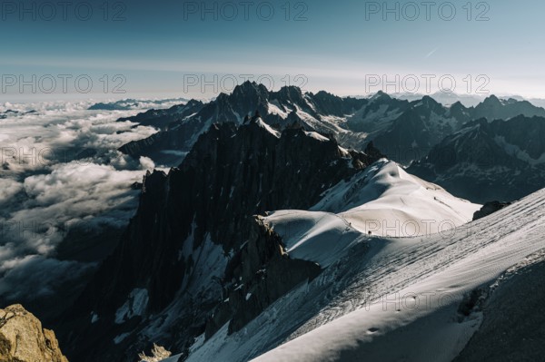 Snow-covered mountain peaks under a blue sky, sunlight and clouds over the landscape, France, Alps, Mont Blanc region