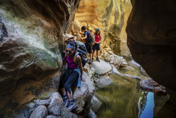 Walkers dodging waterlogged stretches, Torrent de Pareis, Sa Calobra, Majorca, Balearic Islands, Spain