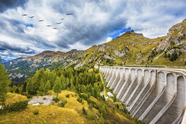 Powerful dam blocked the lake. Mountain Lake Lago di Fedaia, Dolomites. The concept of ecological and extreme tourism