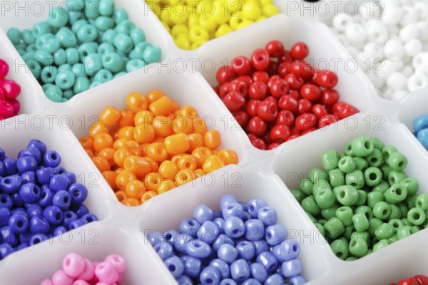 Close up multi colored beads heap in box