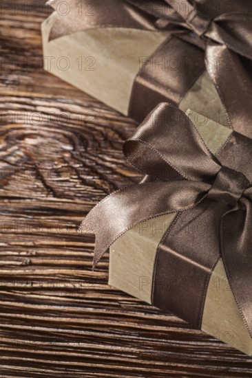 Brown present boxes with tied bow on vintage wooden board
