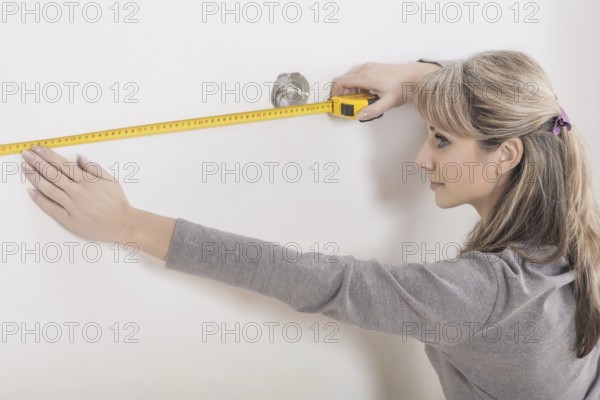 Female working with roulette on wall