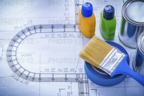 Blueprint with paint brush metal cans plastic bottles and adhesive household tape maintenance concept