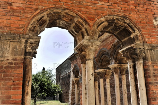 Church ruins of the Cistercian Abbey of San Galgano, Abbazia San Galgano, Gothic, Chiusdino, Tuscany, Italy, Europe, An arched passageway with several stone arches and columns leading into an inner courtyard
