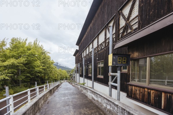 IIZUNA, JAPAN - SEPTEMBER 19, 2024: The now abandoned Nagano 1998 Olympic Spiral luge bobsleigh course on a wet autumn day in Iizuna village, near Nagano, Japan, Nagano, Japan