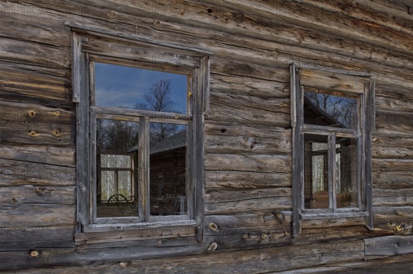 Windows on a weathered old log building, Lapland, Finland