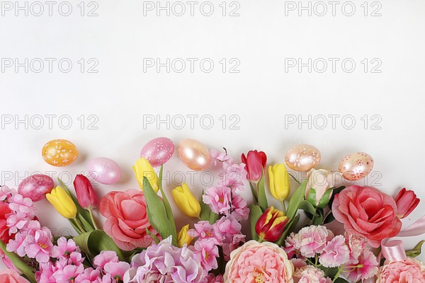 Festive easter banner, spring composition with decorated homemade eggs and blooming flowers, creative concept of easter, ideas for home decorations, template for screen, selective focus