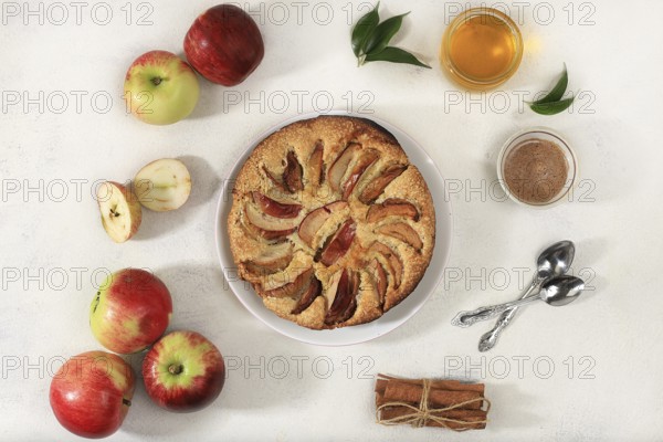 Kitchen background with apple pie, honey, apples, spices, cozy warm concept, hello autumn, hygge style, modern bakery advertisement, selective focus, top view, space for text