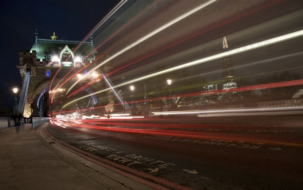 London, UK, December 10, 2015: London Tower Bridge, UK, at night with cars and buses leaving colorful light traces