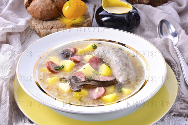 A polished Easter soup with homemade white sausages and mushrooms