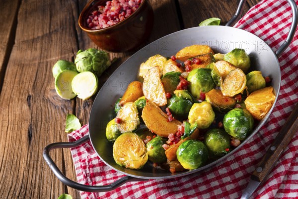 Brussels sprouts potato pan with bacon in a rustic style