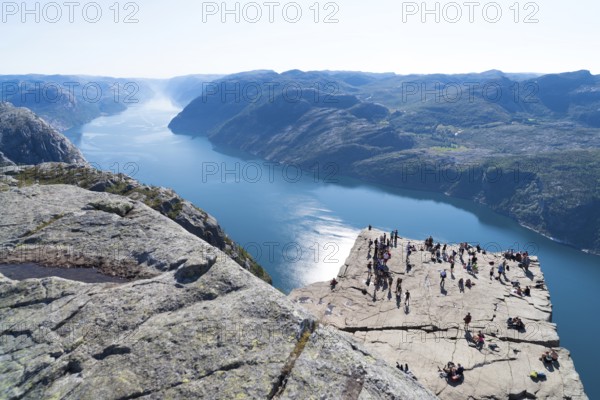 PULPIT ROCK, NORWAY, JULY 26, 2018: Unknown tourists enjoying the stunning view on Pulpit Rock. The Pulpit Rock or Preacher?s Chair is a tourist attraction in the municipality of Forsand in Rogaland county