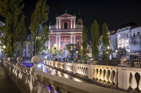 Famous Three Bridges and the Preseren square in the center of Ljubljana illuminated at night, Slovenia