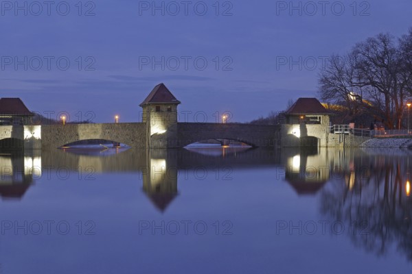 The illuminated Palmengarten weir in the blue hour. Leipzig, Saxony, Germany