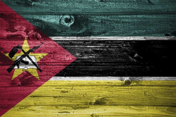 Mozambique flag on wooden planks background wood flag