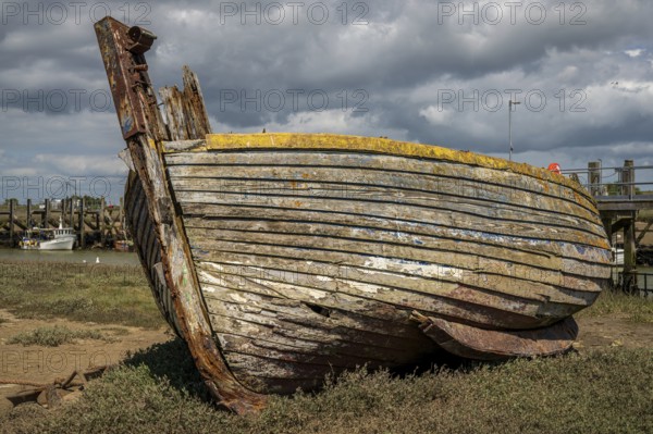 Rye Harbour, East Sussex, England, UK, May 12, 2022: An old shipwreck and some boats on the banks of the river Rother