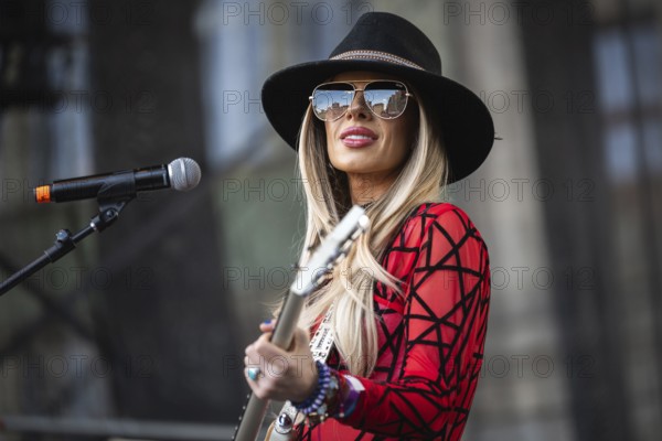 WROCLAW, POLAND - MAY 1, 2025: World Guitar Record concert, 8122 participants played Jimi Hendrix's song Hey Joe on guitars in the Wroclaw market square. Woman guitarist Orianthi