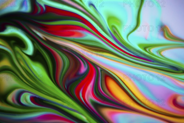 Colorful liquid paints mixed together creating modern abstract