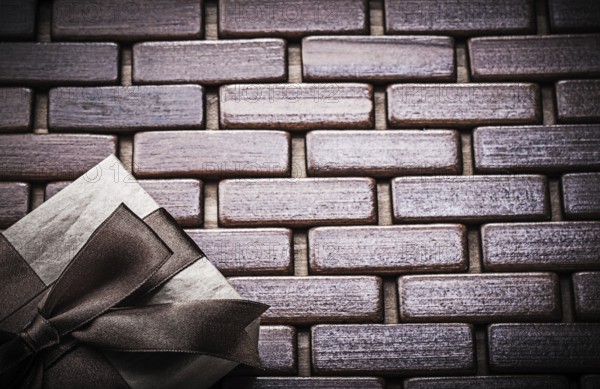 Packed gift box on wooden wicker matting holidays concept