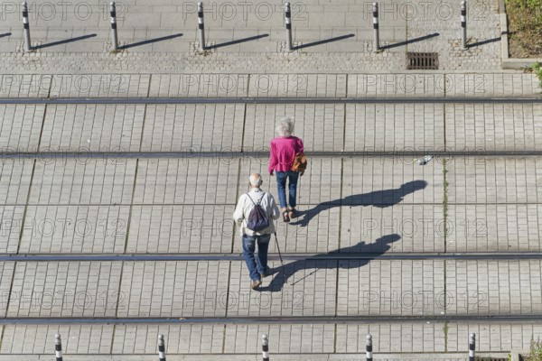 Old pensioner couple on their way through the city centre