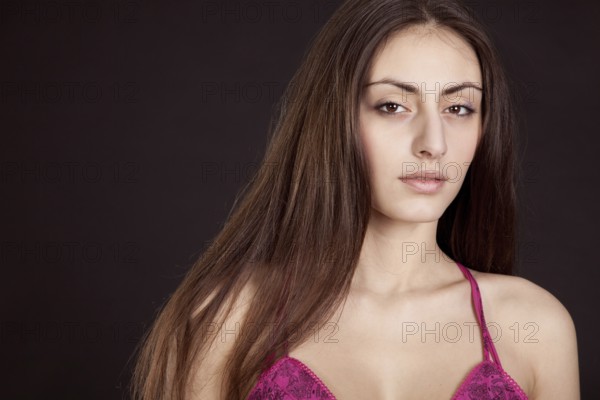 Beauty young girl face on dark background